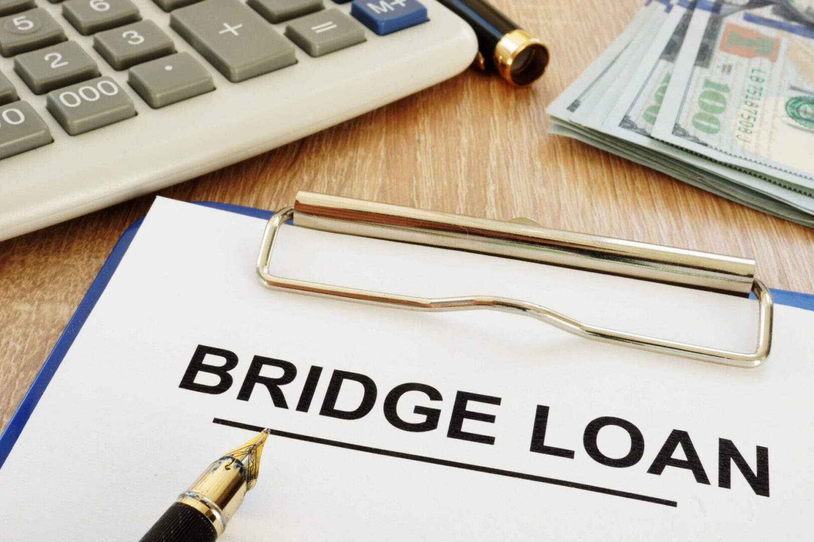 A pen and calculator near a bridge loan document.